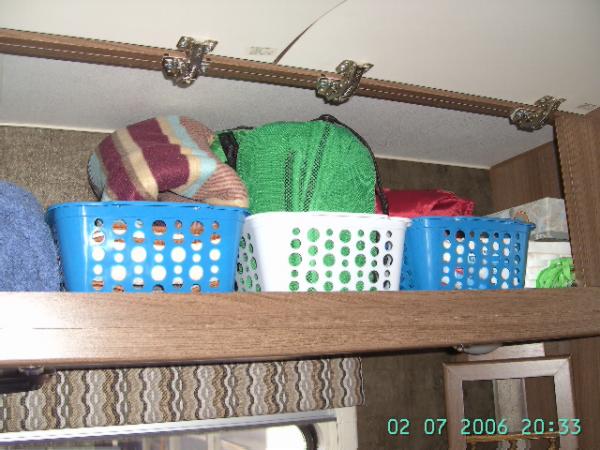 Storage Baskets used to keep objects organized in overhead storage bins.